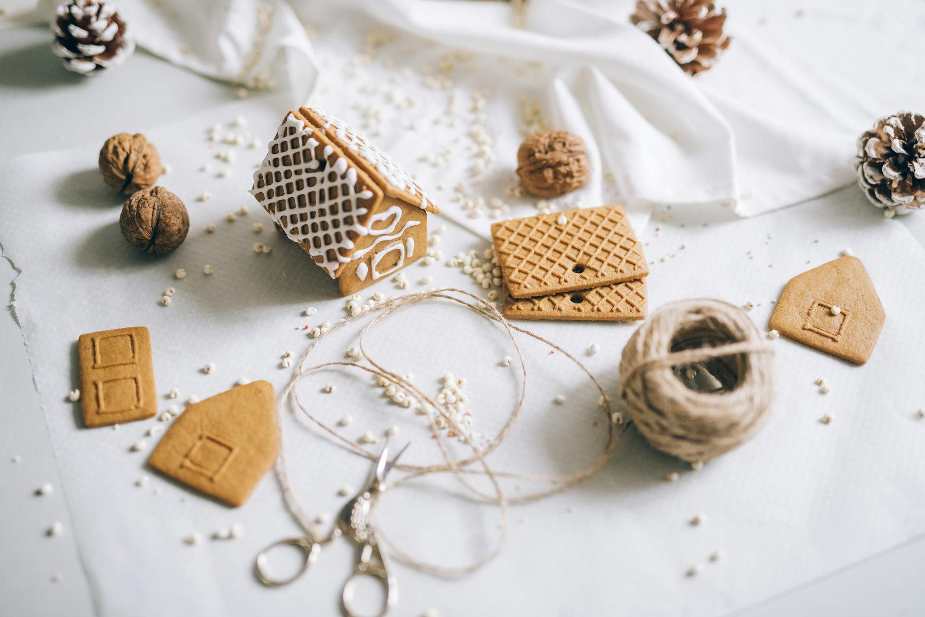 cookies and pine cones on white textile